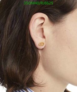 Woman wearing gold oval stud earring