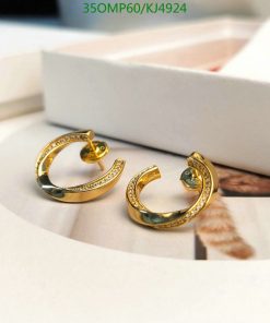 Gold hoop earrings with diamonds on white background.