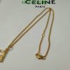 Gold necklace with giraffe pendant on white background.