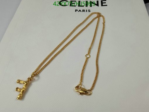 Gold necklace with giraffe pendant on white background.