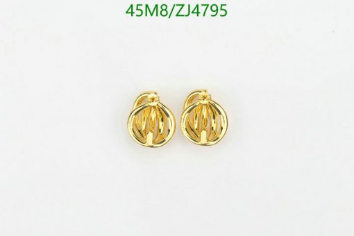 Gold ribbed ball earrings on white.