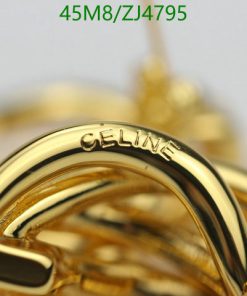 Close-up of a gold Celine-branded accessory.