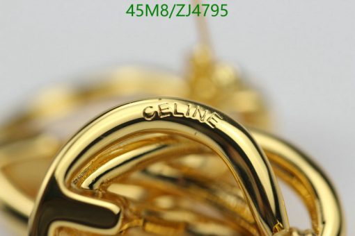 Close-up of a gold Celine-branded accessory.