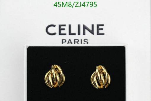 Gold knot earrings on display, Celine Paris brand packaging.