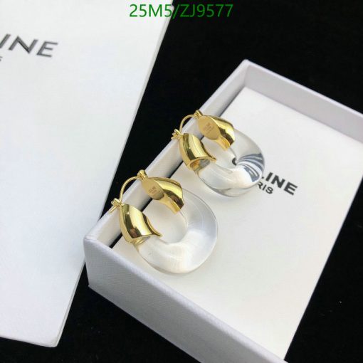 Gold and silver hoop earrings in white box.