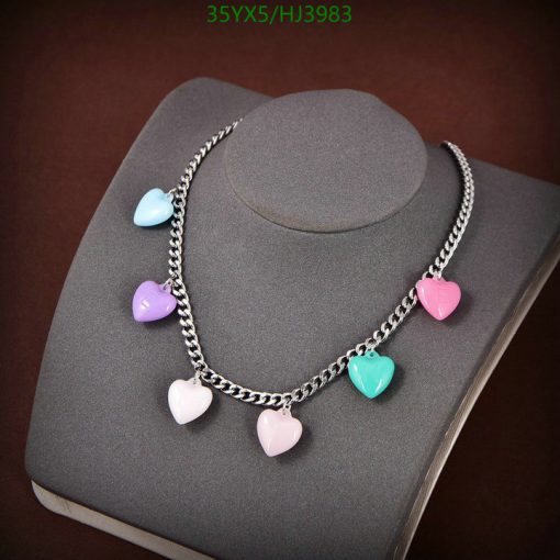 Colorful heart charms necklace on display stand.