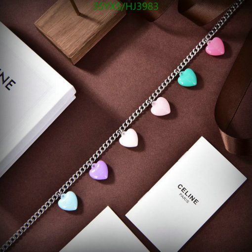 Multicolored heart charms on silver necklace with elegant packaging.