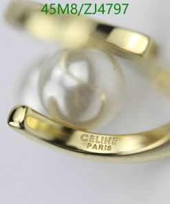 Gold Celine Paris ring with pearl detail.