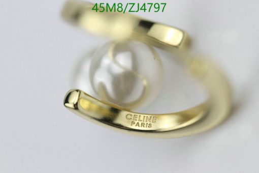 Gold Celine Paris ring with pearl detail.