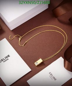 Gold necklace on brown background with luxury packaging.