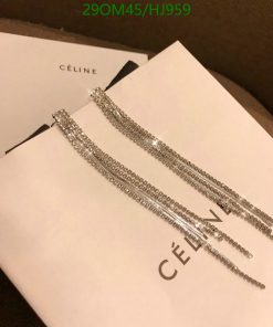 Celine branded sparkling tassel earrings on white background.