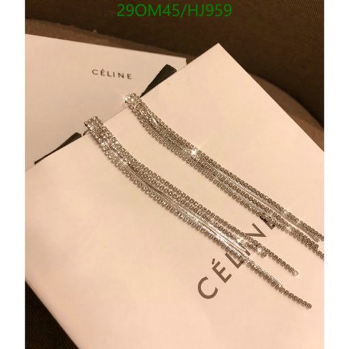 Celine branded sparkling tassel earrings on white background.