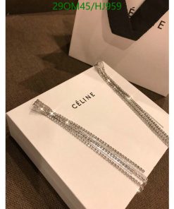 Celine box with sparkly jewelry on a textured surface.