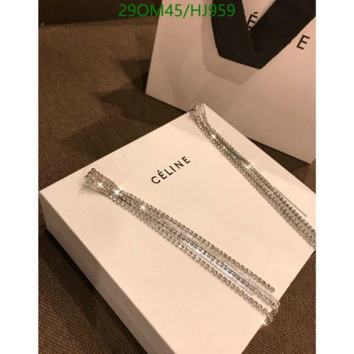 Celine box with sparkly jewelry on a textured surface.