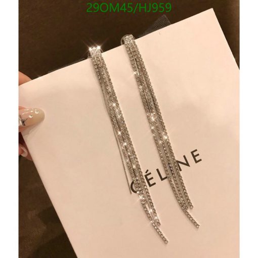 Sparkling long earrings on Céline shopping bag.