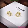 Celine gold diamond earrings on display box.