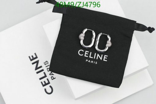 Designer earrings on black pouch with Celine Paris branding.