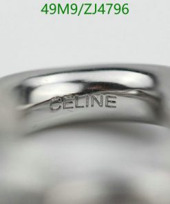 Silver ring with 'CELINE' engraving close-up.