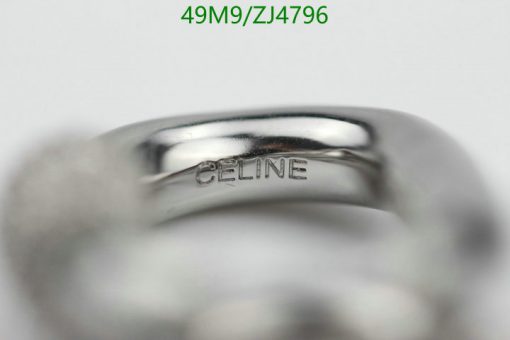 Silver ring with 'CELINE' engraving close-up.