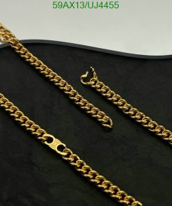 Gold chain necklace on black background.