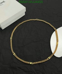 Gold chain necklace on black background with box.