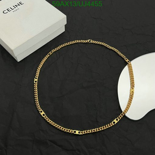 Gold chain necklace on black background with box.