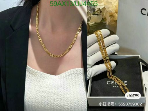 Woman wearing gold necklace, boxed jewelry display.