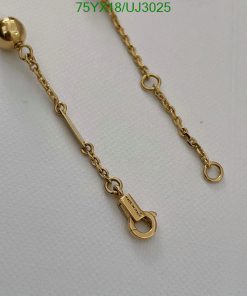 Gold chain with clasp detail on white background.