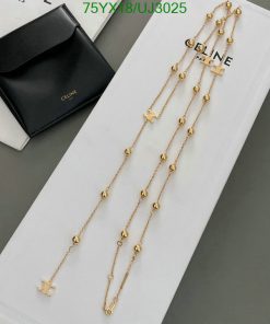 Gold chain necklaces with beads and stars on display.