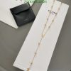 Gold necklace on white display with black wallet