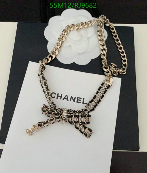 Chanel branded bow pendant with chain on display