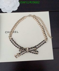 Elegant Chanel crystal bow necklace on book.