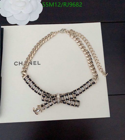 Elegant Chanel crystal bow necklace on book.