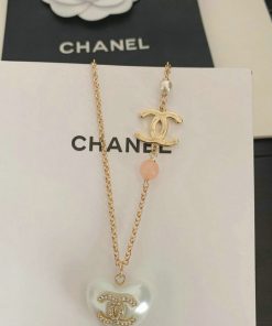 Chanel pearl and pendant necklace on display.