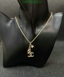 Gold necklace with star pendant on black display.