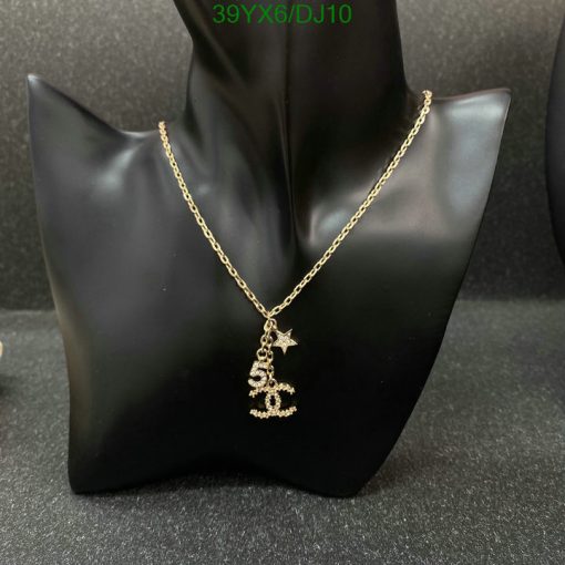 Gold necklace with star pendant on black display.