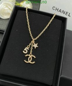 Gold pendant necklace with anchor and star on box.