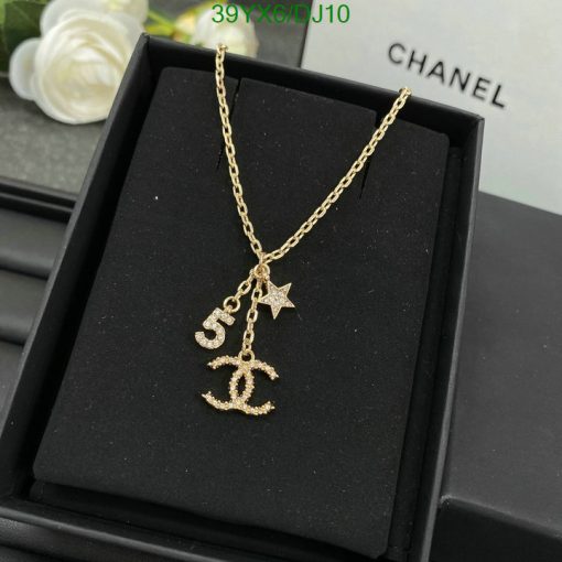 Gold pendant necklace with anchor and star on box.