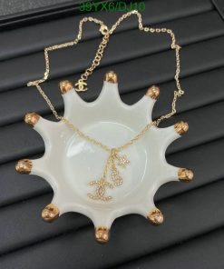 Gold necklace with pendant on white display.