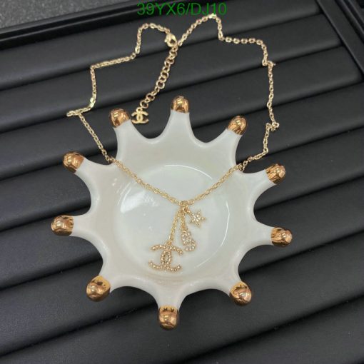 Gold necklace with pendant on white display.