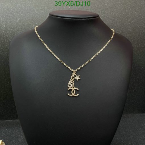 Gold anchor pendant necklace on black display.