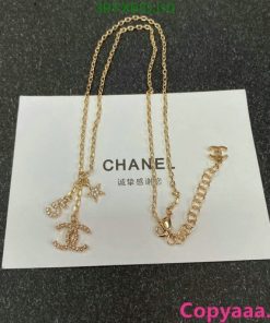 Gold Chanel logo pendant necklace on card.