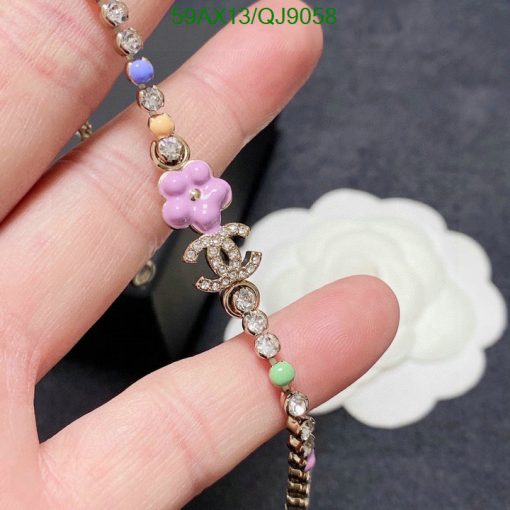 Colorful beaded bracelet with flower charm and crystals.