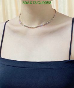 Woman wearing a multicolored gemstone choker necklace.