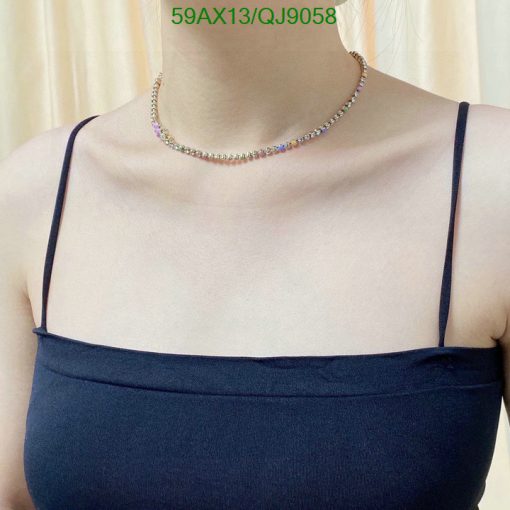 Woman wearing a multicolored gemstone choker necklace.