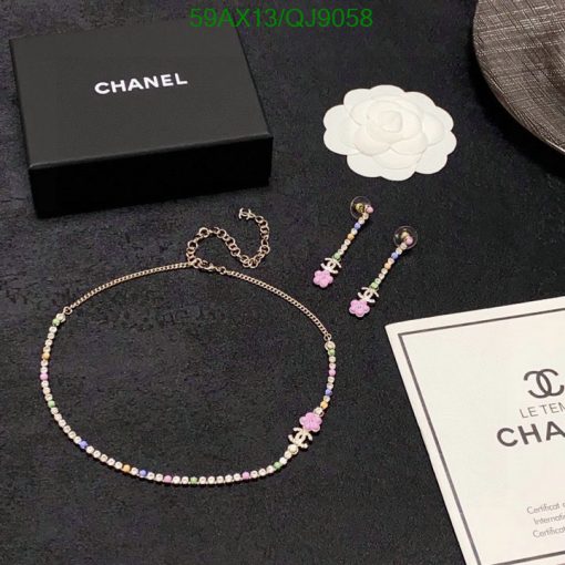 Chanel jewelry set with necklace and earrings on dark background.