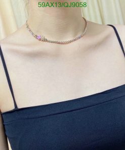 Person wearing multicolored gemstone choker necklace.