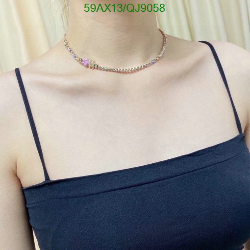 Person wearing multicolored gemstone choker necklace.