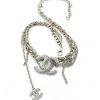 Silver necklace with intertwined chain design and pendant.