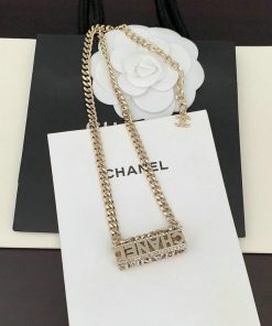 Gold chain necklace on branded background.